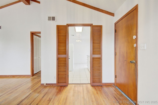 interior space with high vaulted ceiling and light hardwood / wood-style flooring