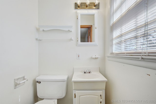 bathroom with toilet and vanity