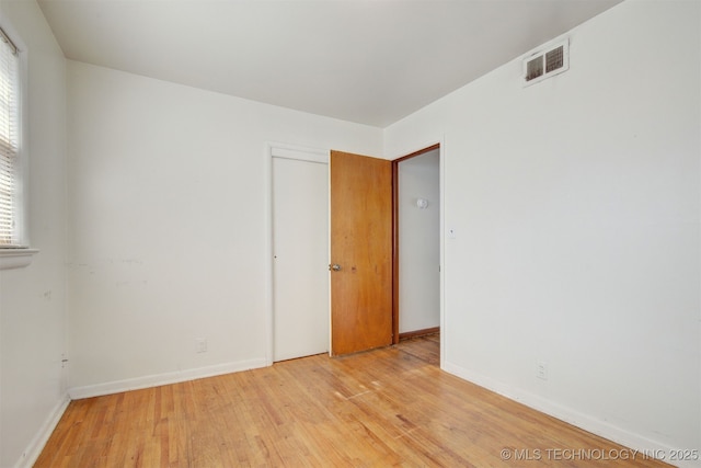 unfurnished room with light wood-type flooring