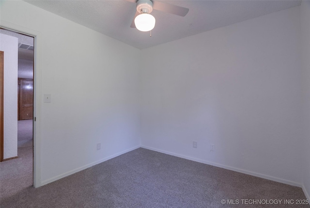 spare room with ceiling fan and carpet