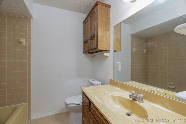 full bathroom with toilet, a textured ceiling, tile patterned floors, vanity, and tiled shower / bath