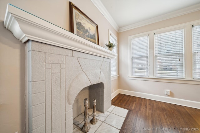 interior details with hardwood / wood-style flooring, crown molding, and a fireplace