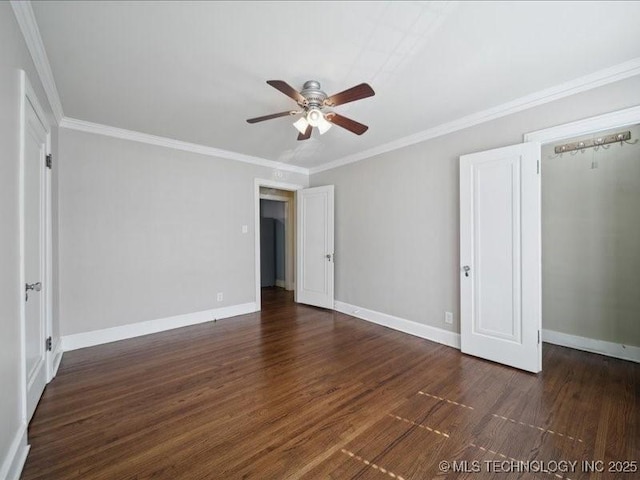 unfurnished bedroom with crown molding, dark hardwood / wood-style floors, and ceiling fan