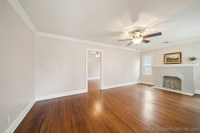 unfurnished living room featuring ceiling fan, crown molding, dark hardwood / wood-style floors, and a fireplace