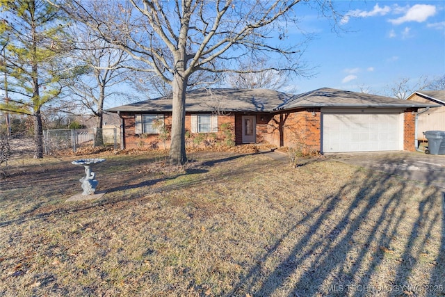 ranch-style house with a garage and a front lawn