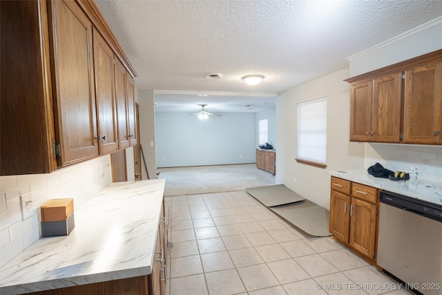 kitchen with tasteful backsplash, stainless steel dishwasher, light tile patterned floors, ceiling fan, and a textured ceiling