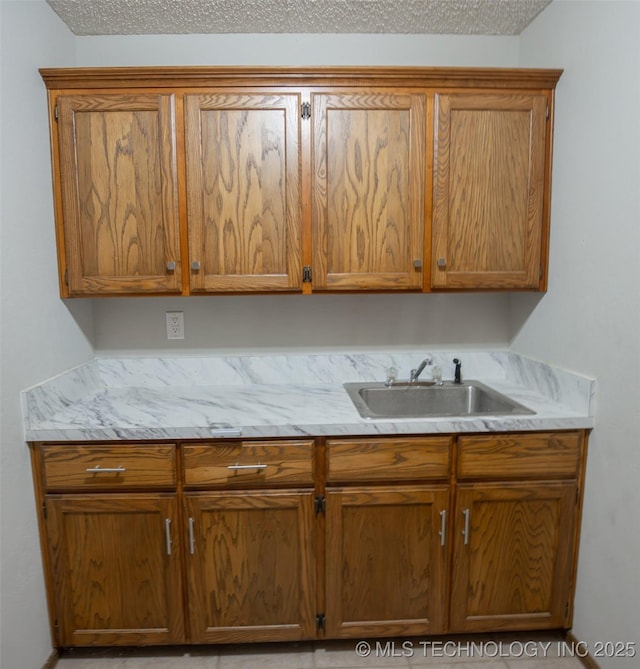 kitchen featuring sink and a textured ceiling