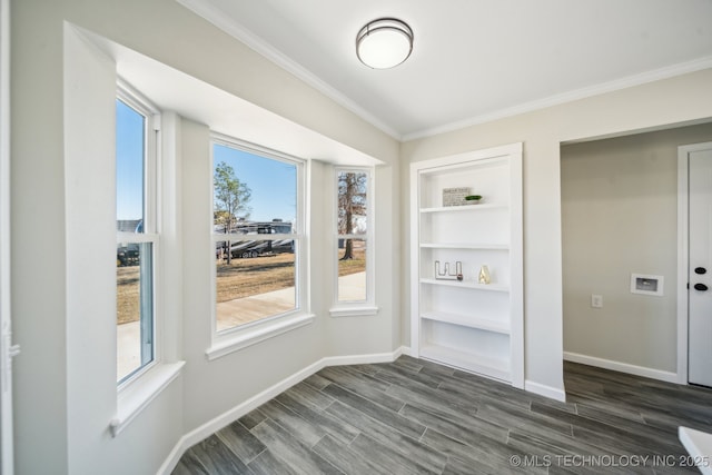 unfurnished dining area featuring ornamental molding, dark hardwood / wood-style flooring, and built in shelves