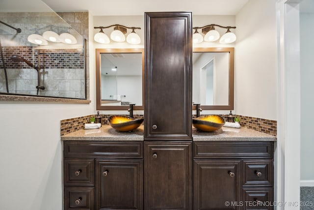 bathroom featuring a shower, backsplash, and vanity