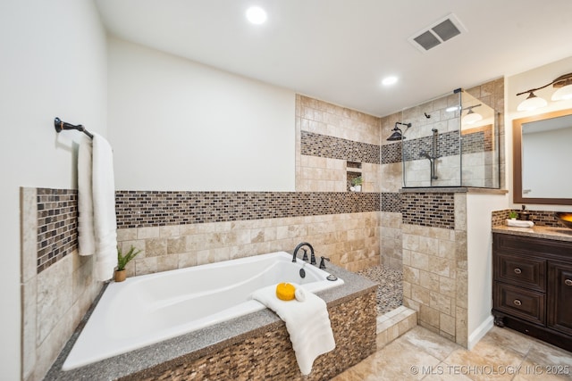 bathroom featuring vanity and separate shower and tub