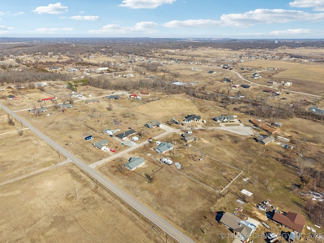 birds eye view of property with a rural view