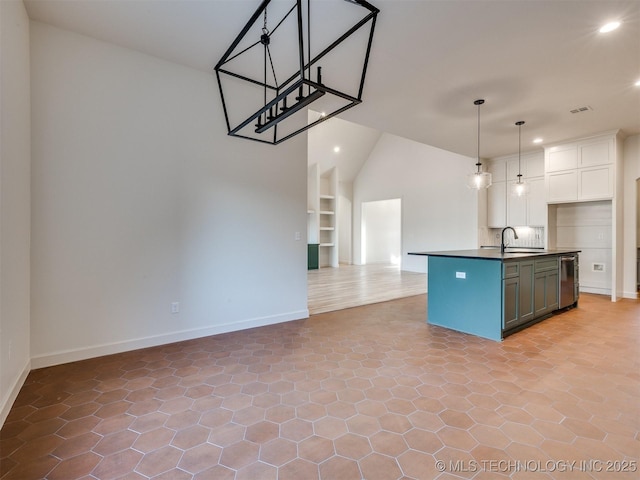 kitchen with built in shelves, recessed lighting, white cabinets, dark countertops, and open floor plan