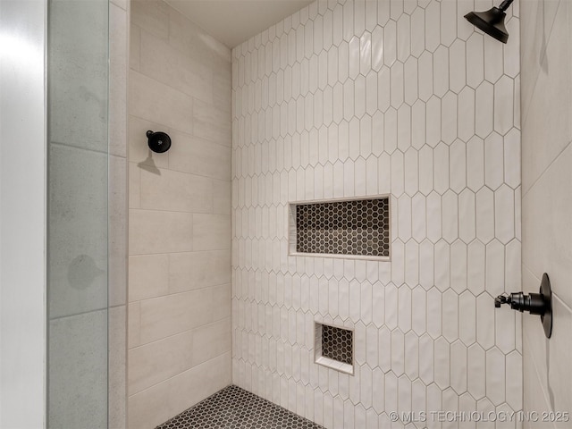 bathroom with a tile shower