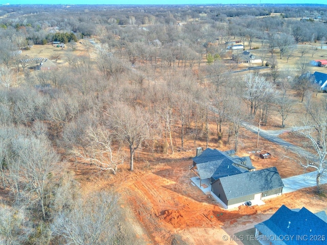 birds eye view of property with a forest view