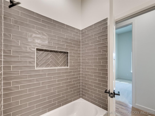 bathroom with baseboards and  shower combination