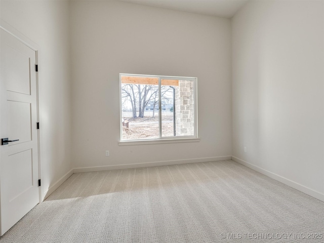 carpeted empty room with baseboards