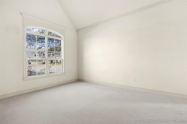 carpeted spare room with vaulted ceiling and ornamental molding