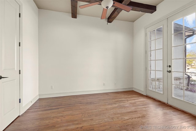 unfurnished room featuring ceiling fan, wood-type flooring, beam ceiling, and french doors