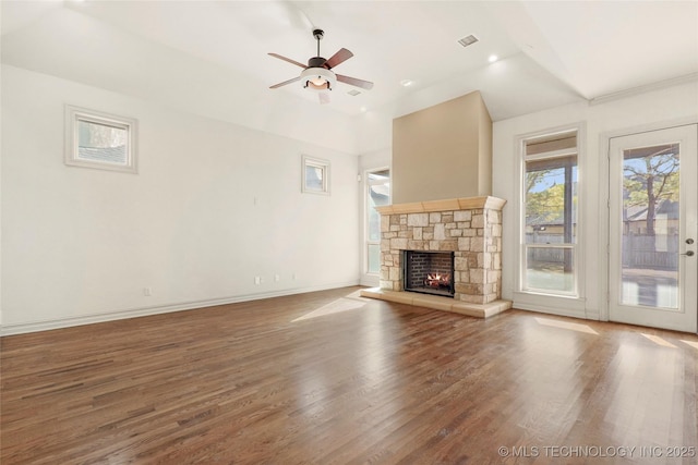 unfurnished living room featuring a fireplace, wood-type flooring, and ceiling fan