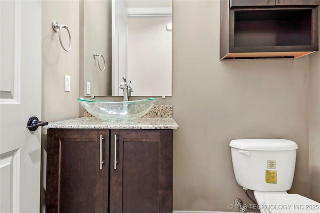 bathroom with toilet and vanity