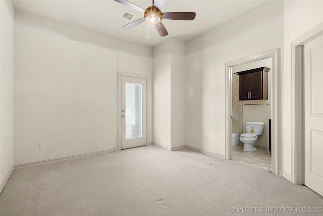 empty room featuring ceiling fan and light colored carpet