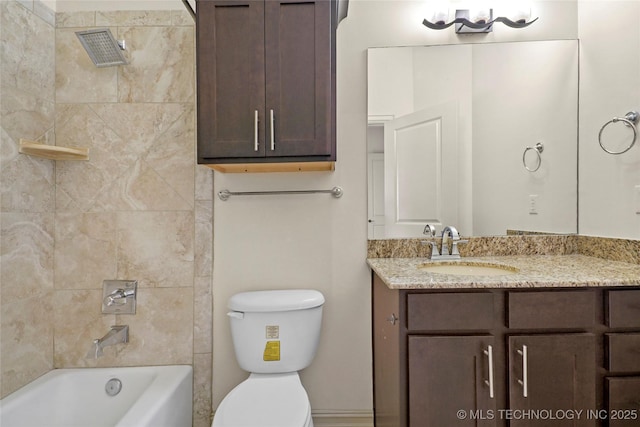 full bathroom featuring toilet, tiled shower / bath, and vanity