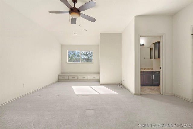 unfurnished bedroom with visible vents, a ceiling fan, baseboards, carpet flooring, and ensuite bathroom