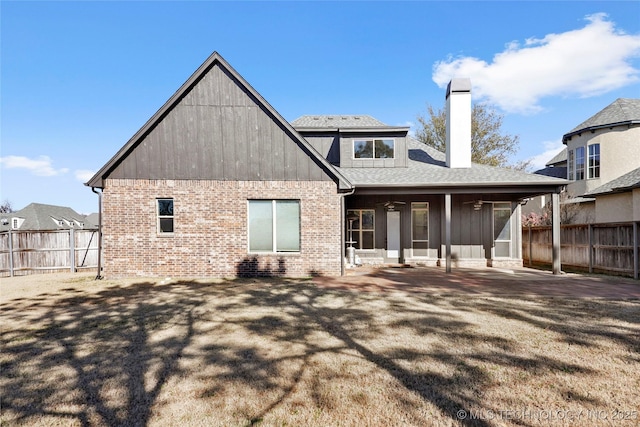 rear view of house with a patio area and a yard