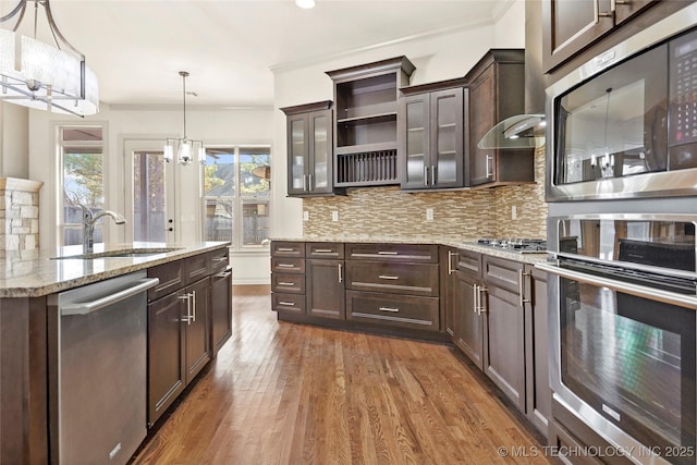 kitchen with sink, hanging light fixtures, appliances with stainless steel finishes, and dark brown cabinetry