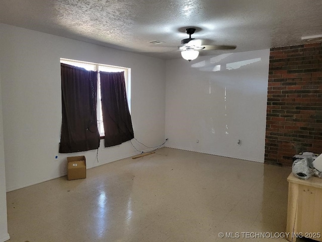 spare room featuring ceiling fan and a textured ceiling