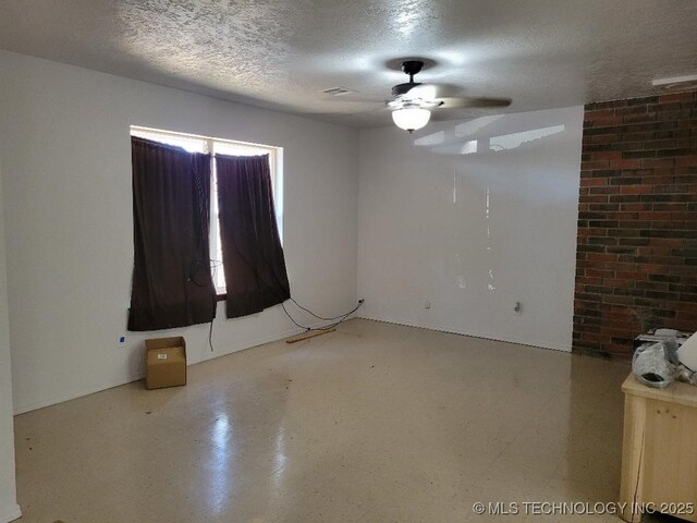 109 S E St, Eufaula, OK 74432 - spare room featuring ceiling fan and a textured ceiling