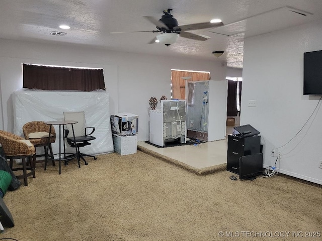 interior space featuring ceiling fan and a textured ceiling