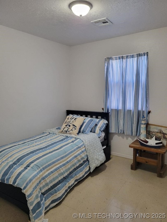 bedroom featuring a textured ceiling