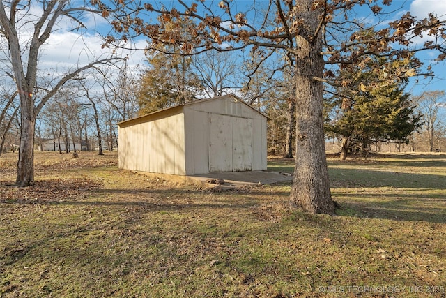 view of outbuilding with a yard