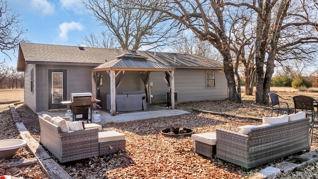 rear view of house featuring a gazebo, outdoor lounge area, a hot tub, and a patio