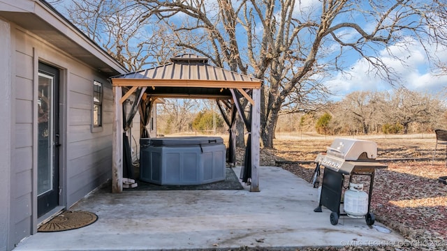 view of patio featuring a gazebo, grilling area, and a hot tub