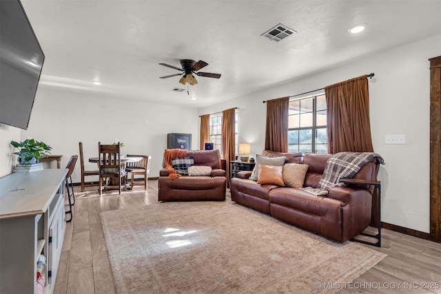 living room with ceiling fan and light hardwood / wood-style floors