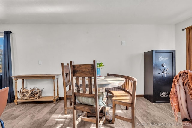 dining space with light hardwood / wood-style floors