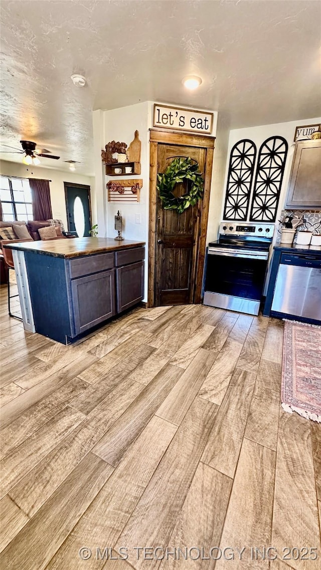 kitchen featuring ceiling fan and stainless steel appliances