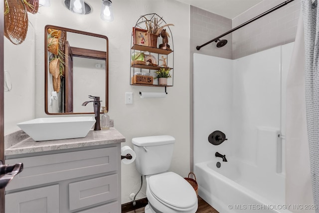 full bathroom with vanity, shower / tub combo, and toilet