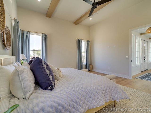 bedroom with beamed ceiling, ceiling fan, and light wood-type flooring