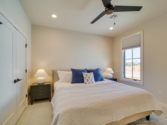 bedroom with light carpet and ceiling fan