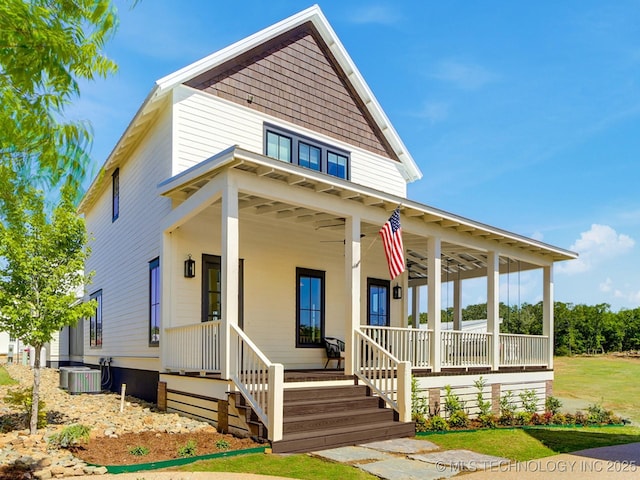 view of front facade with a porch and central AC