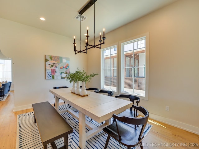 dining room featuring a notable chandelier and light hardwood / wood-style flooring