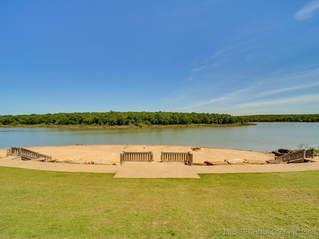 dock area with a water view and a lawn