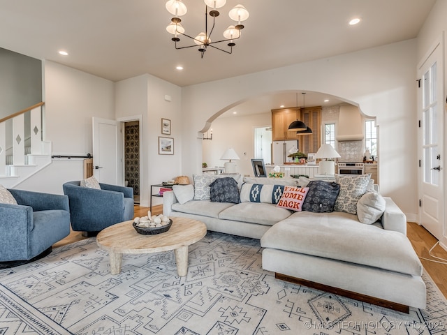 56 Center Ln N, Carlton Landing, OK 74432 - living room with arched walkways, light wood-style floors, recessed lighting, stairs, and a chandelier