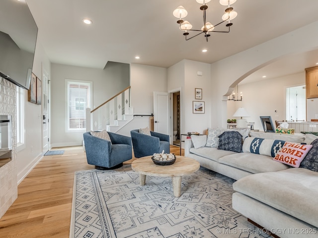 56 Center Ln N, Carlton Landing, OK 74432 - living room with a chandelier, arched walkways, light wood finished floors, recessed lighting, and stairway