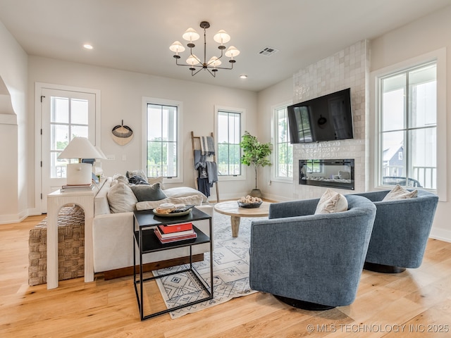 56 Center Ln N, Carlton Landing, OK 74432 - living room with a chandelier, plenty of natural light, light wood-type flooring, a large fireplace, and recessed lighting