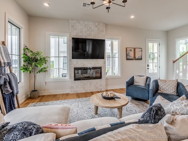 56 Center Ln N, Carlton Landing, OK 74432 - living room featuring wood finished floors, recessed lighting, a fireplace, and a chandelier
