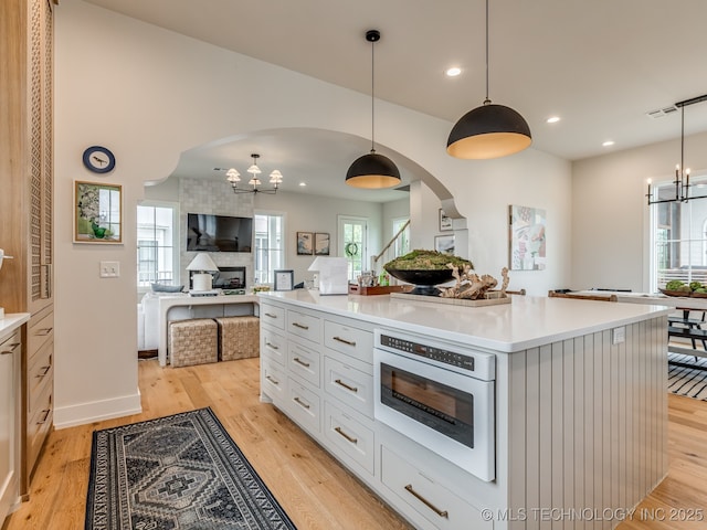 56 Center Ln N, Carlton Landing, OK 74432 - kitchen featuring a chandelier, arched walkways, open floor plan, light countertops, and recessed lighting